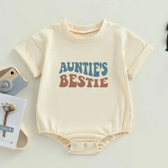 Close-up of the 'Auntie's Bestie' text on a baby romper, showcasing its cute design