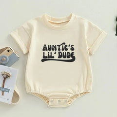 Baby romper with 'Auntie's Lil Dude' printed in bold black font, emphasizing a playful style